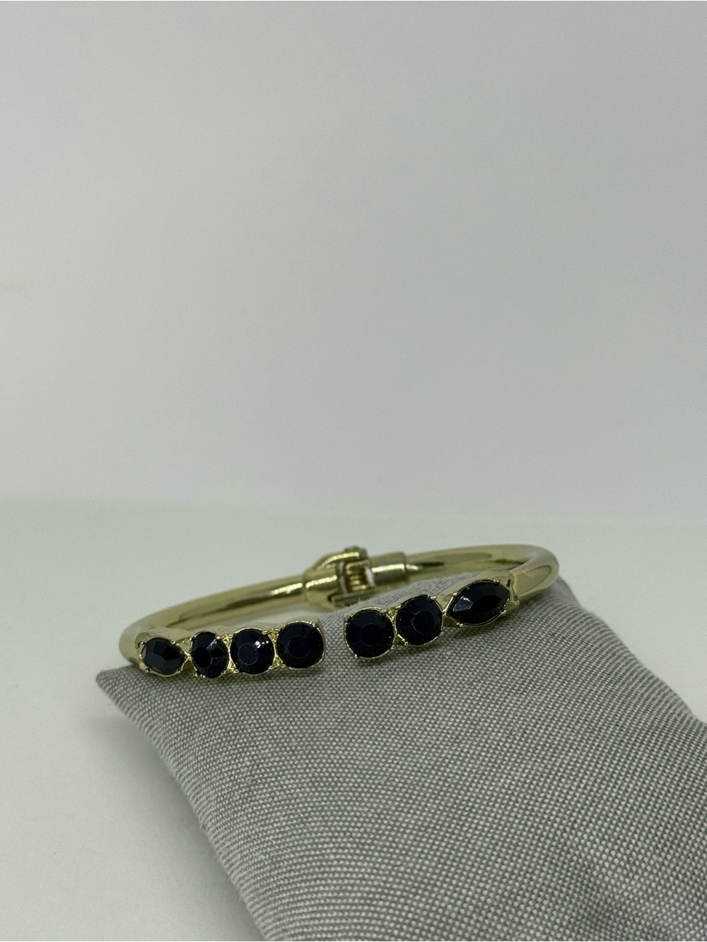 Gold bracelet with navy blue stones